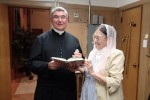 PLMC Board member Cynthia Medvitz presenting Fr. Cizik with a copy of the Oxford Dictionary of Saints