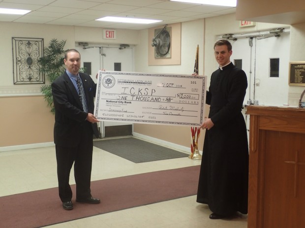 PLMC Secretary Fred Goldbach presenting Canon Andrew Todd with a $1000 donation from the PLMC Seminary fund to the Institute of Christ the King Sovereign Priest.