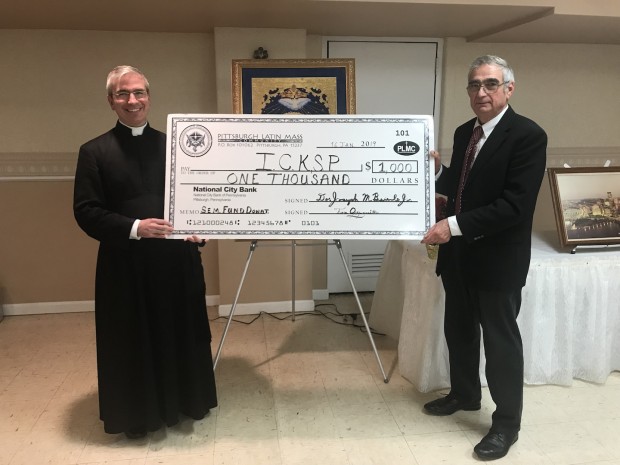 PLMC Director Emeritus Lou Talarico presenting a donation from the 2019 Seminary Fund to son Canon Matthew Talarico